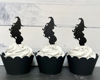 May include: Three black cupcake wrappers with white frosting and black glitter witch silhouette cupcake toppers.