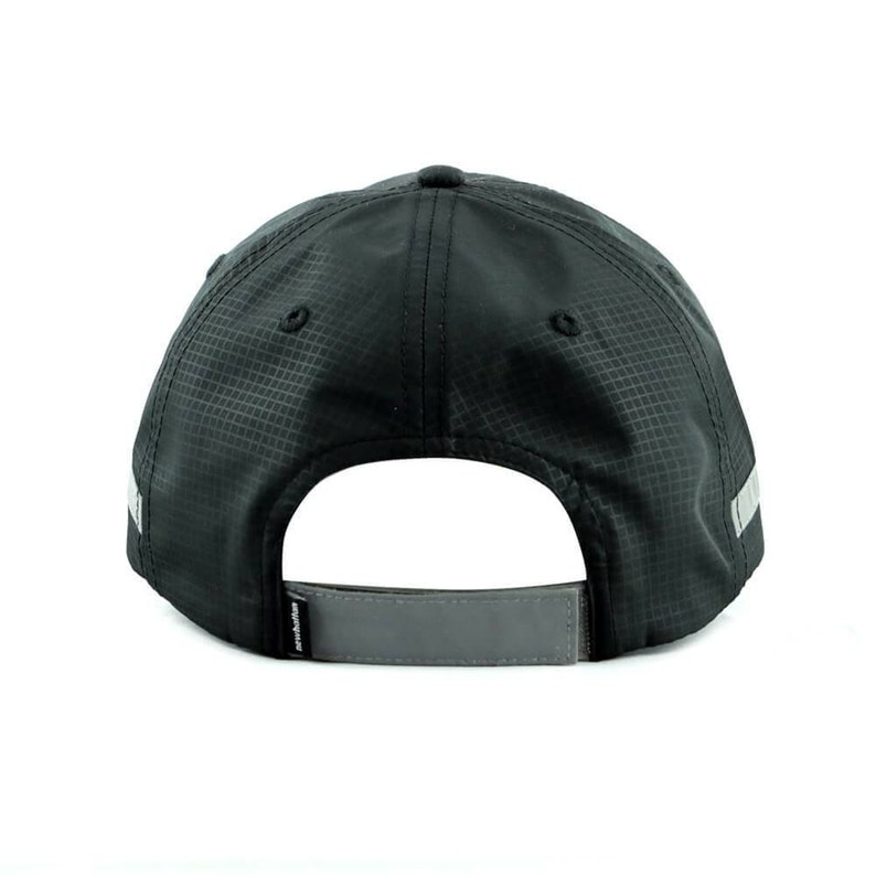 May include: Black baseball cap with a reflective gray stripe around the brim and a reflective gray strap in the back. The cap has a textured, woven fabric.