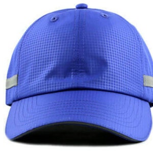 May include: A blue baseball cap with a reflective strip around the brim. The cap has a textured fabric and a curved brim.