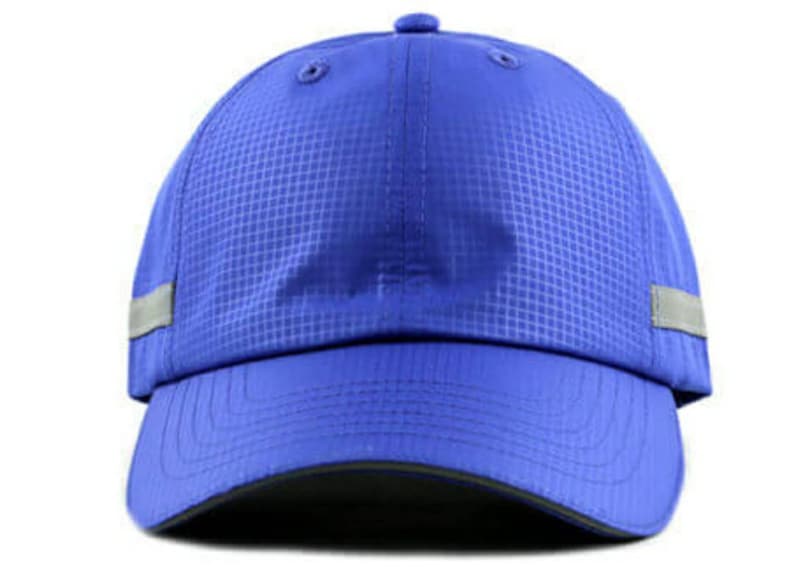 May include: A blue baseball cap with a reflective strip around the brim. The cap has a textured fabric and a curved brim.