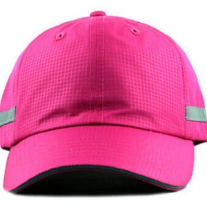 May include: A pink baseball cap with a reflective grey stripe on each side. The cap has a dark green brim.