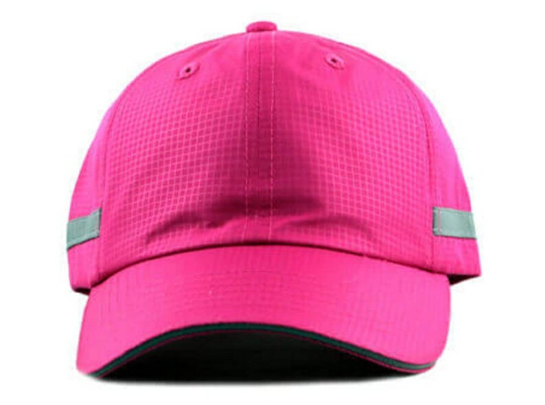 May include: A pink baseball cap with a reflective grey stripe on each side. The cap has a dark green brim.