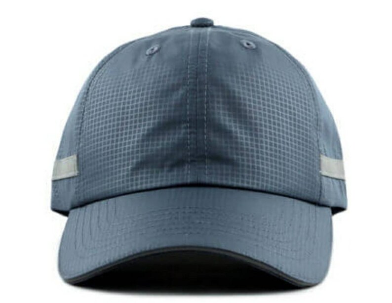 May include: A blue baseball cap with a reflective strip on the side. The cap has a textured fabric and a curved brim.