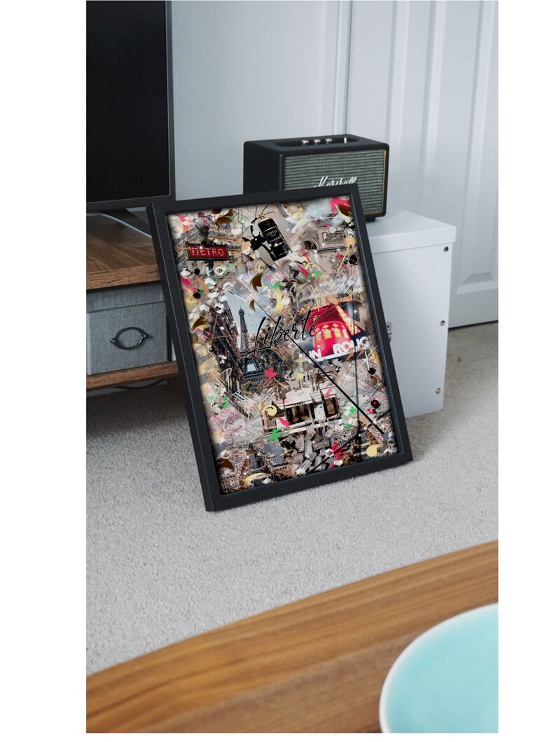 May include: A framed collage of colorful images and text, including the words "Liberte" and "Sicilia". The collage is set against a white background and is framed in black.