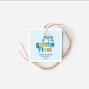 May include: A square gift tag with a light blue background and the words "gimme five!" in colorful letters. The tag also includes the text "THANKS FOR COMING TO MY PARTY! - WELLS" and is attached to a natural twine string.