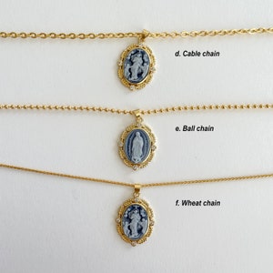 May include: Three gold necklaces with different chain styles: cable, ball, and wheat. Each necklace features a pendant with a blue and white cameo image.