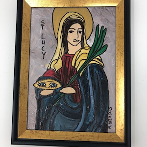 May include: A framed painting of a woman with a halo, holding a palm branch and a plate with two eyes. The painting is titled "St. Lucy" and signed "A.M.2020".