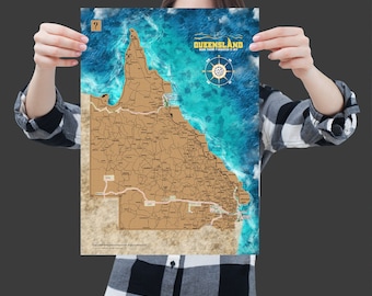 May include: A map of Queensland with a scratch-off surface, featuring a detailed outline of the state's borders and internal regions. The map has a nautical theme with a blue ocean background and the text "Queensland Been There Scratch It Off".