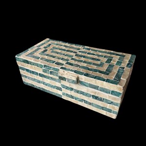 May include: Rectangular decorative box with a mosaic tile design. The box features alternating rows of teal and off-white tiles, creating a geometric pattern on the lid and sides. The box has a small rectangular clasp.