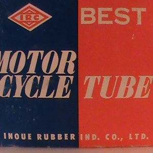 May include: A red and blue box with the text "BEST MOTORCYCLE TUBE" and the logo "IRC" in a diamond shape. The bottom of the box reads "INOUE RUBBER IND. CO., LTD."