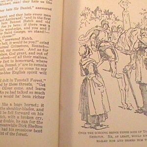 May include: A black and white illustration of a group of people on horseback. The people are dressed in medieval clothing and are riding through a forest. The text "Over the echoing bridge there rode up Young Master Dick Shelton. He, at least, would know, and then hailed him and begged him to explain." is at the bottom of the image.