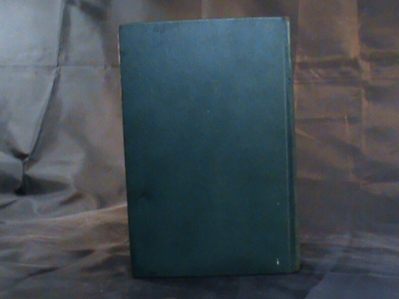 May include: A dark green hardback book with no visible title or author.