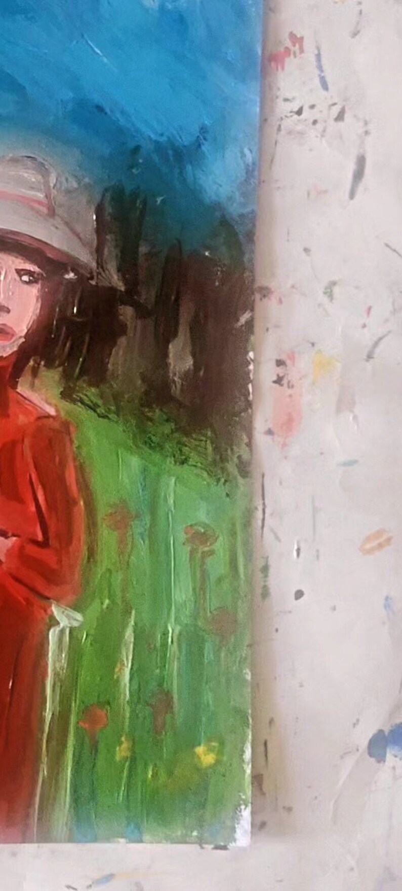 May include: A painting of a woman wearing a white hat and a red dress. She is standing in a field of green grass with brown trees in the background. The sky is blue.