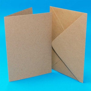 May include: A set of two brown cardstock blank greeting cards with envelopes. The cards are made of recycled paper and have a textured surface.