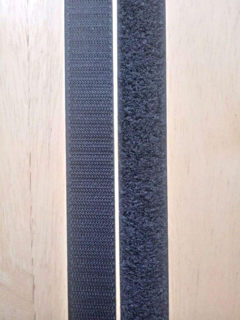 May include: Two strips of black hook and loop fastener tape. The hook side is on the left and the loop side is on the right.
