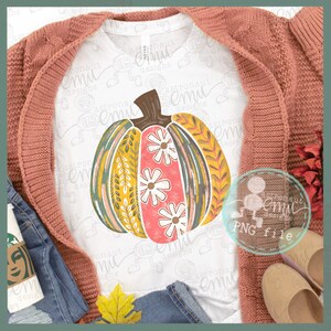 May include: A colorful, hand-painted pumpkin with a floral design. The pumpkin is painted in shades of green, yellow, pink, and white. The design includes leaves, flowers, and swirls.