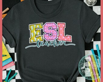 May include: Dark gray t-shirt with the text "ESL teacher" in colorful, block letters. The letters are yellow, pink, and red with decorative patterns. The shirt is knotted at the bottom.