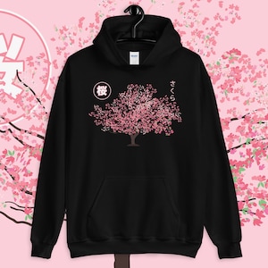 May include: Black hoodie with a pink cherry blossom tree graphic and the Japanese characters "桜" and "さくら" on the front.