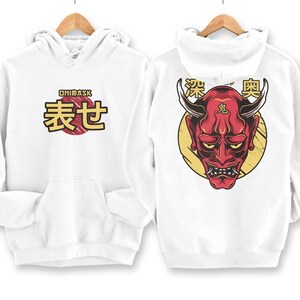 May include: White hoodie with a red and yellow Oni mask graphic on the back and the text "ONIMASK 表せ" on the front.