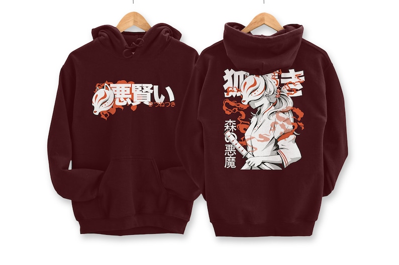 May include: Burgundy hoodie with a white graphic print of a woman wearing a fox mask and holding a sword. The text "狐 憑 い" is printed on the front of the hoodie and "森 の 悪 魔" is printed on the back.