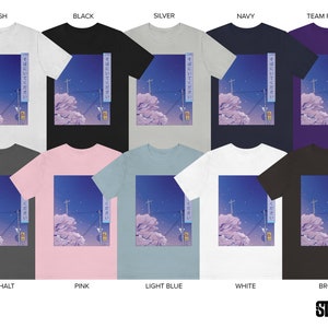 May include: A collection of t-shirts featuring a graphic of a cityscape at night with Japanese text that reads "そばにいてください" which translates to "Please be by my side". The t-shirts are available in a variety of colours, including ash, black, silver, navy, team purple, asphalt, pink, light blue, white, and brown.