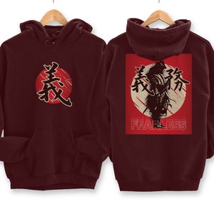May include: Burgundy hooded sweatshirt with a red circle and Japanese characters on the front and a red circle with Japanese characters and a silhouette of a samurai with the word "FEARLESS" underneath on the back.