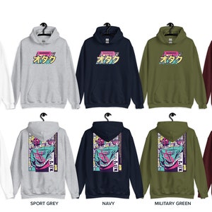 May include: Ten different colour variations of a hooded sweatshirt with a graphic print on the front and back. The front print says "StateMD" in a pink and blue font. The back print is a colourful graphic of a person with a large head and a pink and blue background. The colours of the sweatshirts are white, sport grey, navy, military green, and maroon.