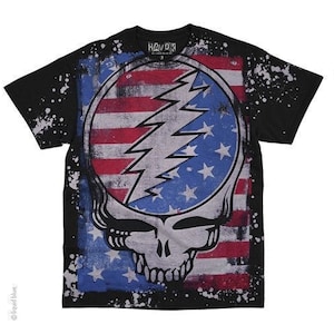 May include: Black t-shirt with a distressed American flag design featuring a Grateful Dead Steal Your Face logo. The shirt has a white splatter paint effect.