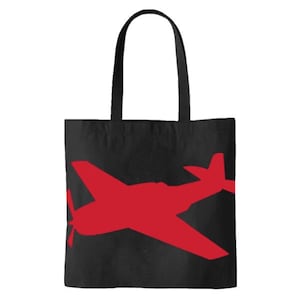 May include: Black canvas tote bag with a red silhouette of a vintage airplane.