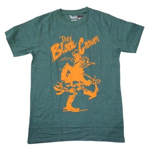 May include: Green t-shirt with the text "The Black Crowes" in orange, along with an orange illustration of a musician playing a guitar. The shirt is made of a soft material and has a crew neck.