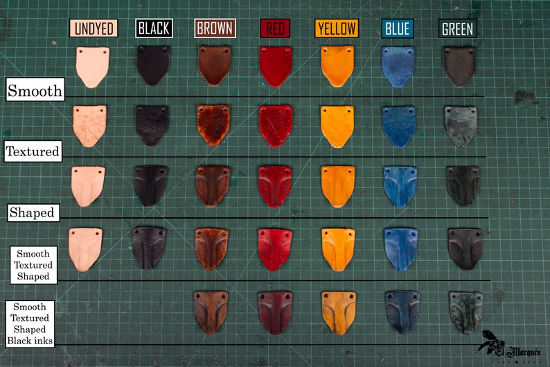May include: Leather samples in various colors and finishes, including undyed, black, brown, red, yellow, blue, and green. The samples are arranged in a grid with three rows and seven columns. Each row represents a different finish: smooth, textured, and shaped. The samples are all in the shape of a shield.