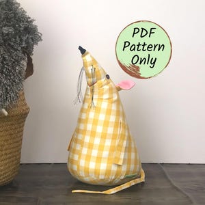 May include: A stuffed mouse toy made of yellow and white gingham fabric with a pink ear, a black button eye, and thin black whiskers. A circular graphic in the upper right corner contains the text PDF Pattern Only in black lettering.
