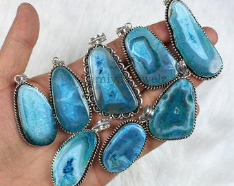 May include: Eight silver pendant charms with blue agate stones. Each pendant features a silver bezel setting with a detailed border. The stones are a mix of light and dark blue shades.