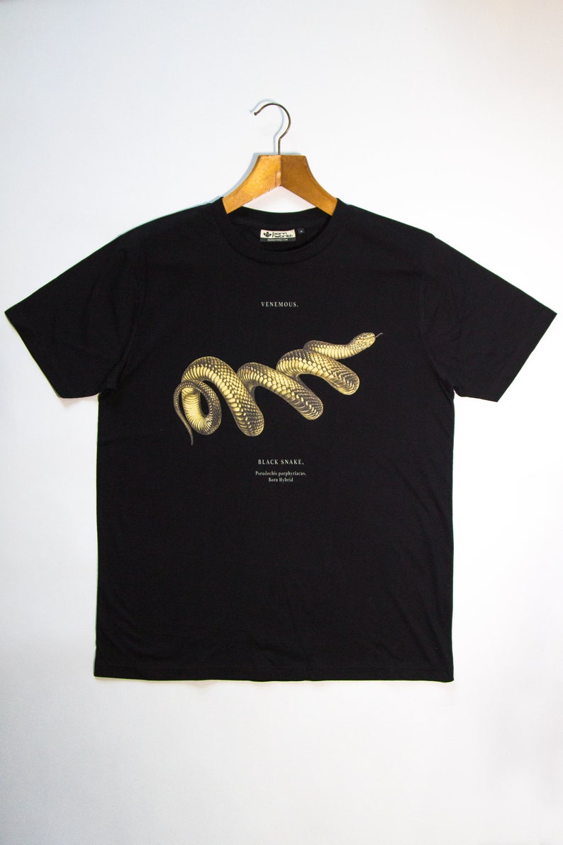 May include: Black t-shirt featuring a graphic print of a black snake with the text "VENEMOUS" and "BLACK SNAKE. Pseudechis porphyriacus.  Ron Hyde" printed on the front.