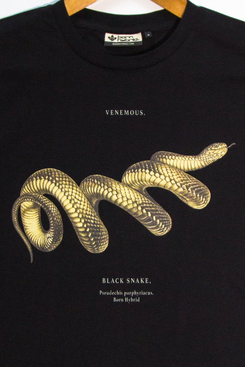 May include: Black t-shirt featuring a graphic of a black snake with the text "VENEMOUS." and "BLACK SNAKE, Pseudechis porphyriacus. Born Hybrid."