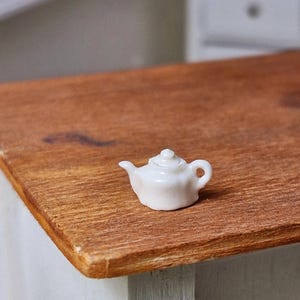 1:24 scale ceramic white teapot with removable lid.
