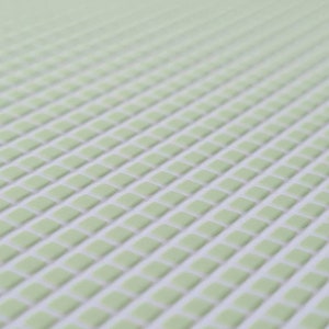 May include: A close-up of a light green textured surface with a grid pattern of raised squares.