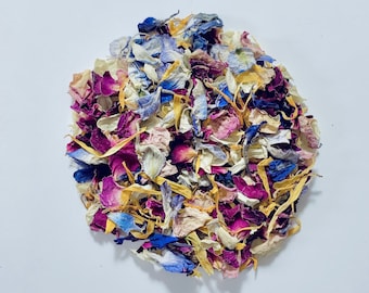 May include: A pile of dried flower petals in shades of pink, yellow, blue, and white. The petals are perfect for scattering at weddings or other special events.