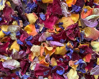 May include: A mix of dried flower petals in shades of purple, red, orange, and yellow. The petals are scattered on a surface and are ready to be used for crafting or decoration.