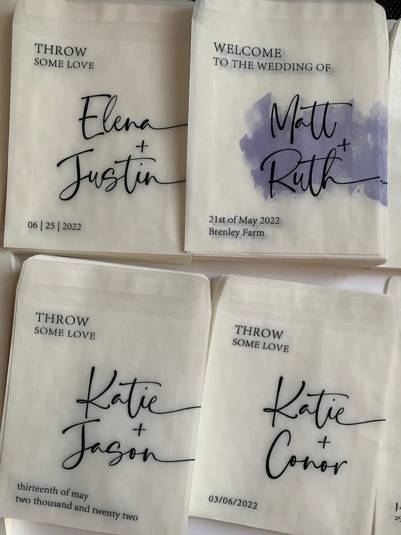 May include: Four white paper bags with black text. Each bag has a different wedding couple's names and wedding date. The text on the bags reads "Throw some love".