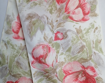 May include: A white fabric table runner with a floral pattern. The flowers are pink and red with green leaves. The runner has a subtle sheen.