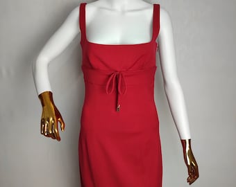 May include: A red sleeveless dress with a square neckline and a tie at the waist.