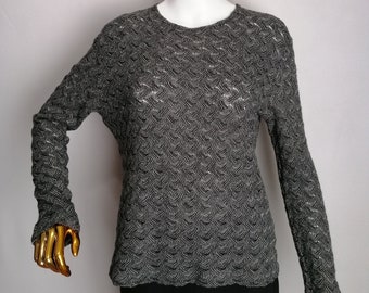 May include: A gray and silver long-sleeved sweater with a textured pattern.