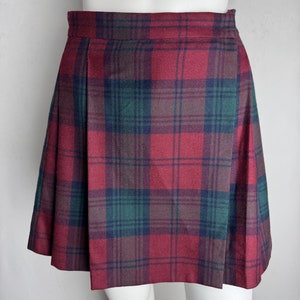 May include: A red, green, and black plaid pleated skirt.