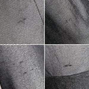 以下が含まれることがあります： 細かい織り目の黒い布のクローズアップ。布は控えめな光沢があり、わずかにざらざらした感触です。