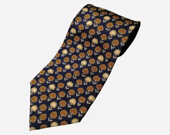 May include: A navy blue tie with a repeating pattern of brown and cream flowers.