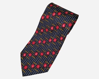 May include: A dark blue silk tie with a repeating pattern of red flowers and gold crescent moons on a striped background.