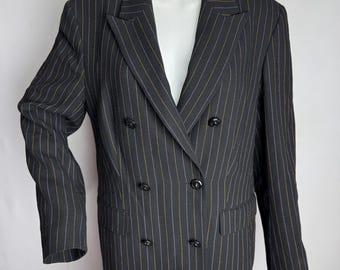 May include: A black double-breasted blazer with vertical pinstripes in white and yellow. The blazer has a notched lapel, four black buttons on the front, and two pockets. The blazer is displayed on a mannequin.