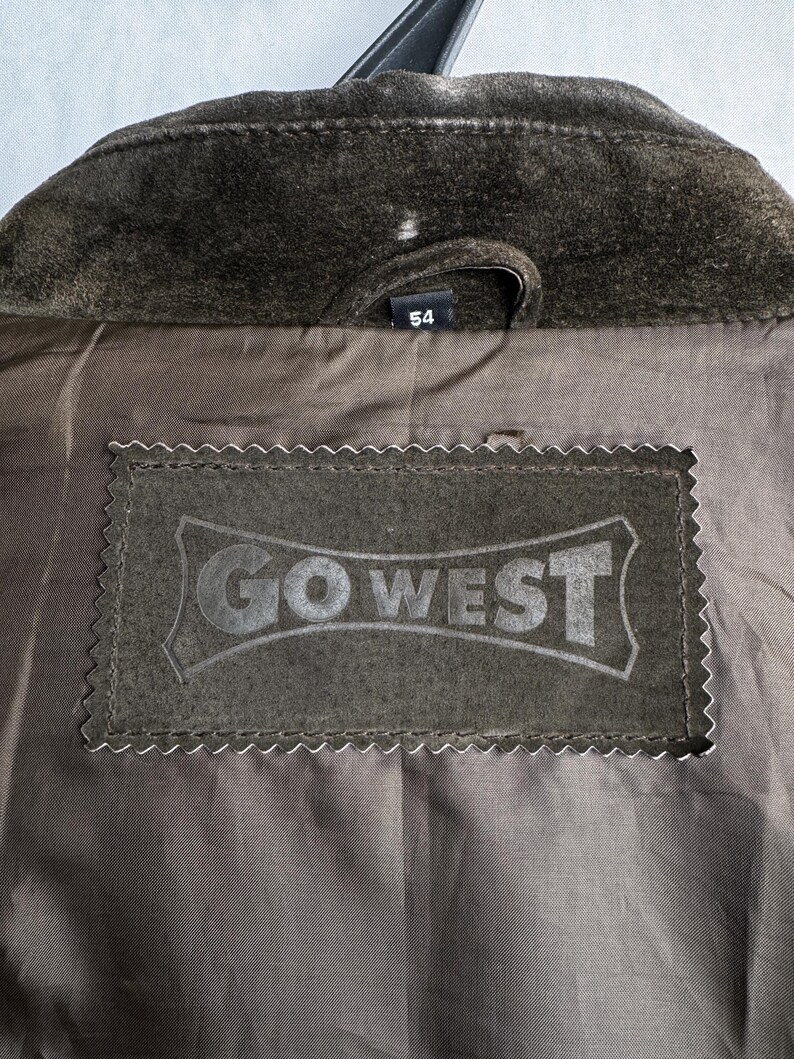 May include: A brown suede jacket with a label that says "GO WEST" and a size tag that says "54".