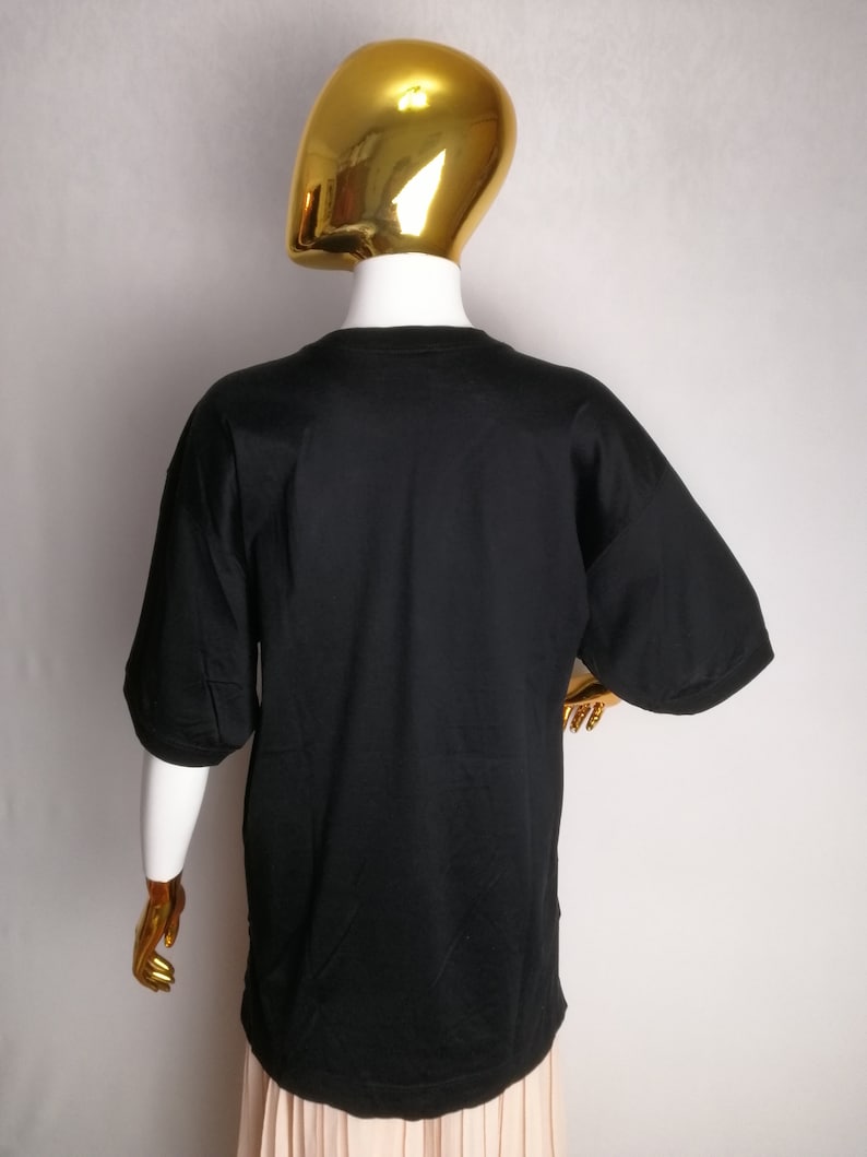 May include: Black short-sleeved t-shirt with a crew neck.